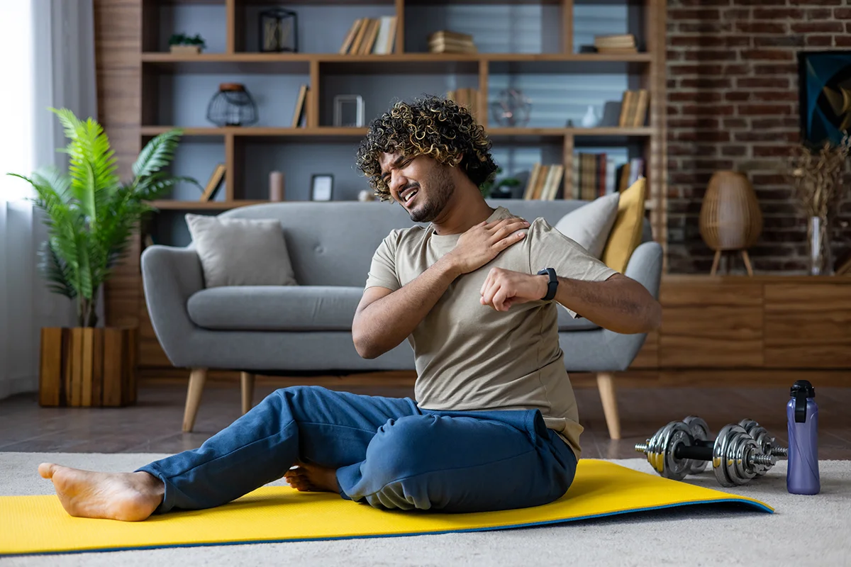 Man holding shoulder in pain - shoulder orthopaedics Boise