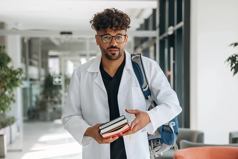 the medmentor podcast Confessions of a Medical Student displayed by med student carrying books